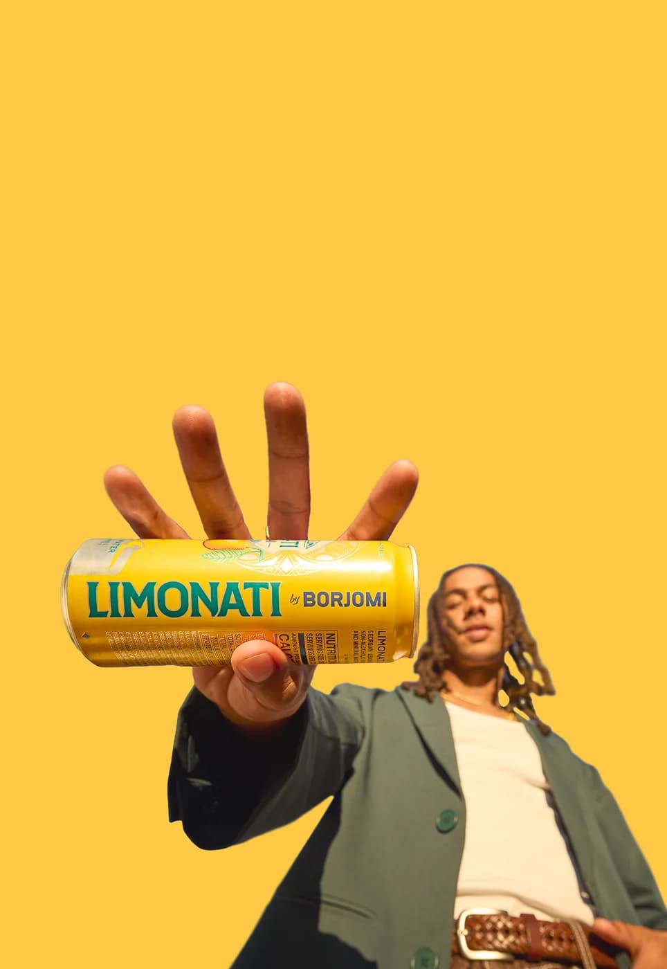 Borjomi and Limonati cans arranged with drinks on a marble table, teal background